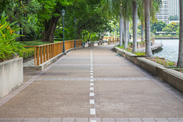 Concrete path way in public park. text space.