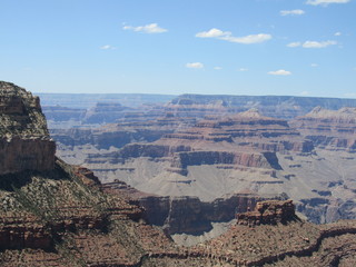 Views of the Grand Canyon on a sunny day with blue sky and clouds, as seen from the South Rim Trail