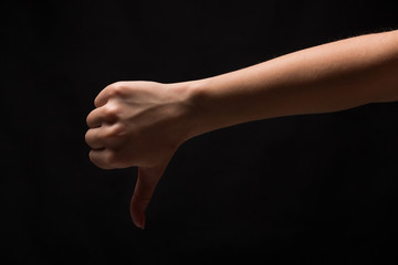 Fototapeta premium Thumb down sign isolated on black background