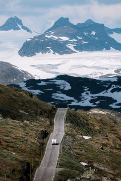 Caravan on a mountain road in Norway with glacier in the background