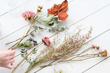 dried flowers and twigs on white background. beautiful creative room decor composition