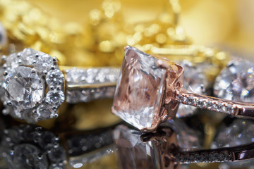 Luxury gold Jewelry diamond and pink topaz rings with reflection on black background