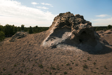 Fototapeta premium Big rock surrounded by sand