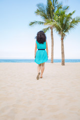 Young beautiful asian woman is walking on the beach