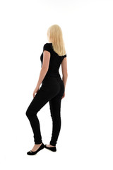 Fototapeta premium full length portrait of blonde girl wearing black clothing, isolated on white background.