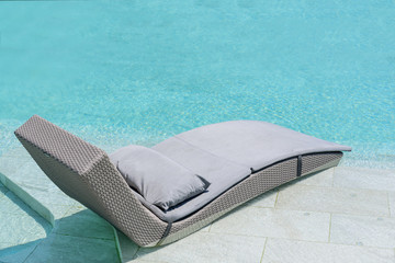 Relaxing or Leisure rattan chair bed in swimming pool .
