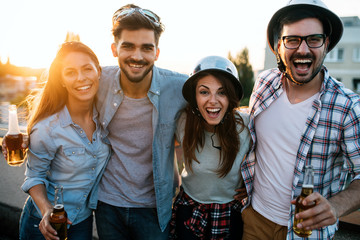 Group of happy friends having party on rooftop