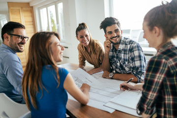 Image of business partners discussing documents and ideas