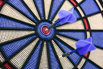 Two darts on a dart board.