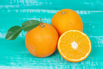 orange fruit on color table background.
