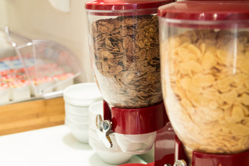 Cornflakes dispenser. Two types of cereals. Self-service breakfast