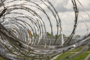 Razor wire on prison yard fence