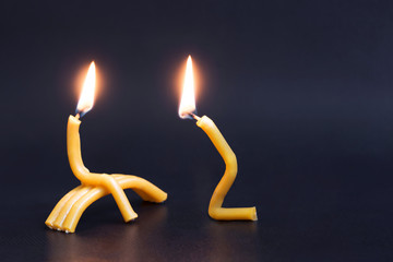 forgive relationships. Two burning church candles. Husband apologizing wife. Man asking woman for...