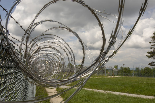 Prison yard fencing with razor wire
