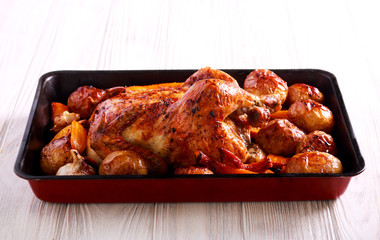 Chicken, potato, carrot and orange baked