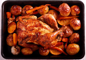 Chicken, potato, carrot and orange baked
