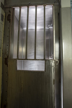 Metal door with bars on shower stall in prison