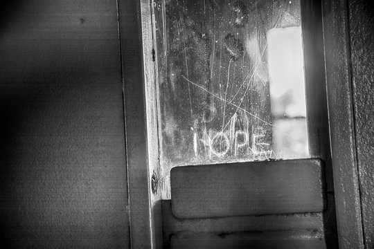 Hope in prison door in black and white