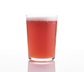 Glass of craft fruit beer on white background.