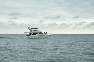 Fototapeta na wymiar Riding a luxury white yacht in the open sea. Travel, entertainment, tourism