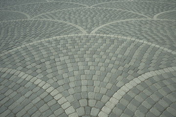 Sidewalk tile laid out from sea pebble stones in a beautiful mosaic pattern. Cobblestone pavement.