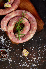 Raw spiral pork sausages