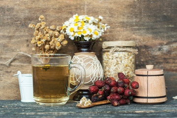 cup of herbal chamomile tea with fresh daisy flowers on wooden background. doctor treatment and prevention of immune concept, medicine - folk, alternative, complementary, traditional medicine 