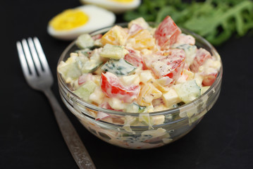 Vegetable Salad Bell Pepper, Tomato, Cucumber, Eggs and Mayonnaise. Health Vegan salad. Glass Bowl Black Board.