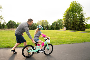 Girl learning to ride a bike