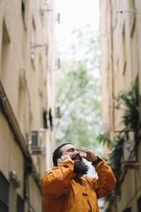Bearded man with smartphone on a street in the city of Madrid