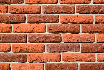 Masonry brick wall structure, the wall of the house. Brick wall with variegated brown bricks. Used as a background. Stone wall texture. Decorative tile. Textured background. Marble. Stone background. 