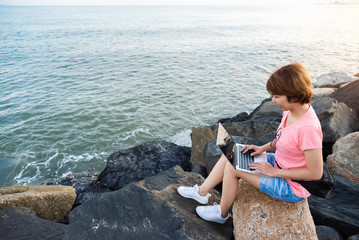 Young Asian Woman Freelance working with laptop.