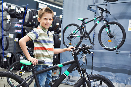 Boy and bicycle in sport store