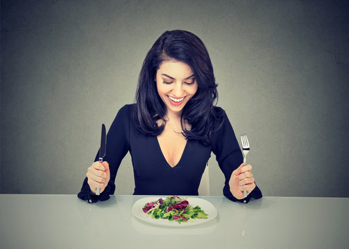 Cheerful woman enjoying healthy salad