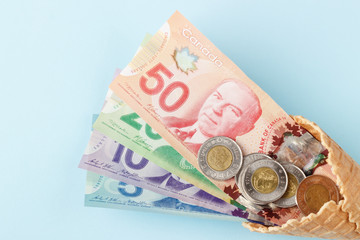 Obraz na płótnie Canvas Canadian banknotes on blue background