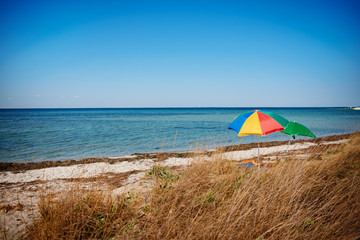 umbrella on the beach with cloudy blue sky in background