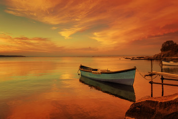 fishing boats on the sea beach during sunset