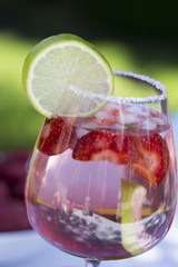 Homemade Summer Berry Drink. Lemonade with  strawberry with lime, mint in glass