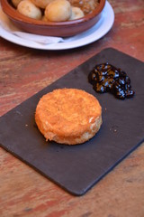 Brie cheese baked with breadcrumbs. Served with cranberry marmalade.