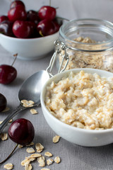  Breakfast of organic oatmeal with milk and fresh cherries