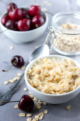  Breakfast of organic oatmeal with milk and fresh cherries