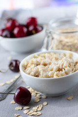  Breakfast of organic oatmeal with milk and fresh cherries