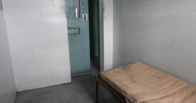 Door closing on cell door of old prison.
