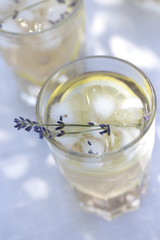 Lavender lemonade in cocktail glasses. Lemonade with lemons and lavender