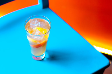 Orange juice on blue wooden background, top view. Closeup glass of cocktail