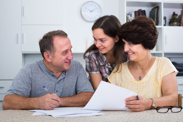 Man and woman signing documents