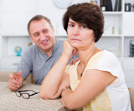 Sad mature woman experiencing family problems