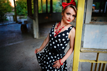 beautiful young woman posing in retro dress