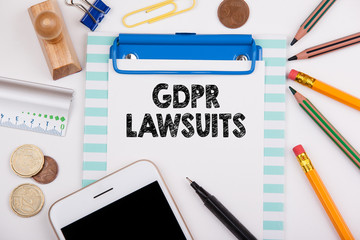GDPR and lawsuits, business background. Office desk with stationery and mobile phone