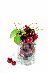 Berries of sweet ripe cherry in glass vase isolated on white
